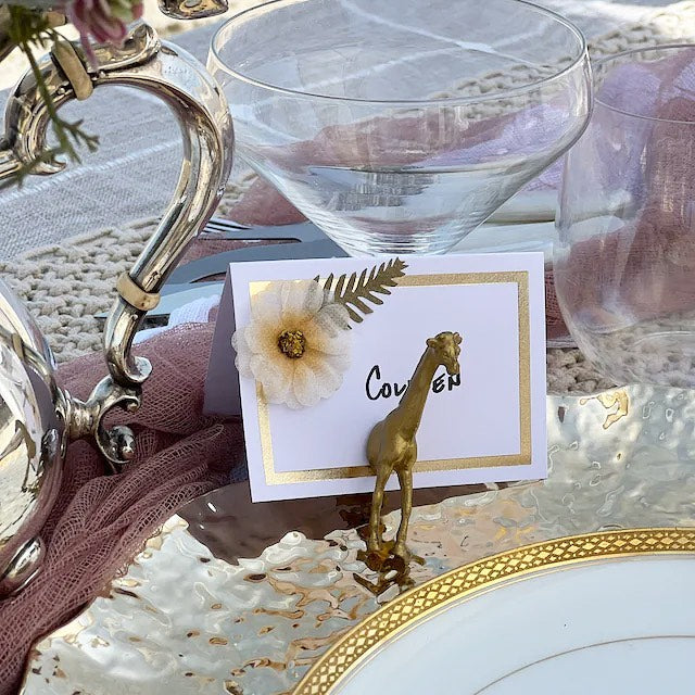 Gold safari animal place card holders for whimsical wedding table seating.