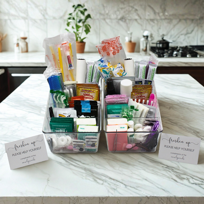 Luxury wedding bathroom amenity basket filled with guest essentials and custom signage.