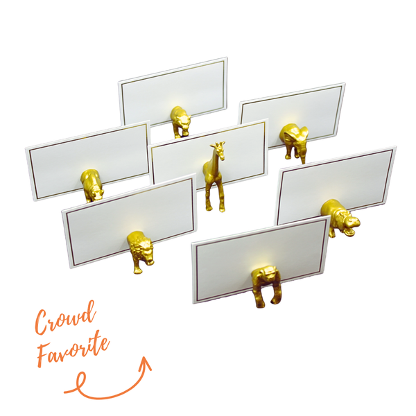Set of gold safari animal place card holders featuring lions, giraffes, and elephants for wedding favors by Edie Rose.