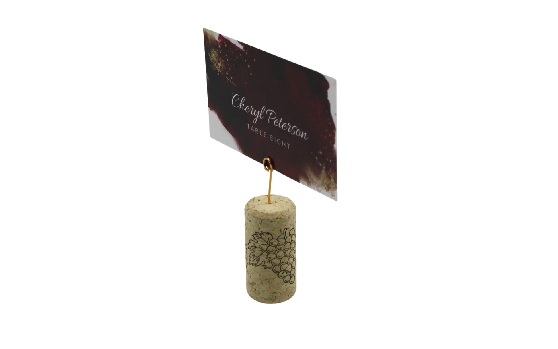 Close-up of mini round gold wire place card clip in a wine cork with a card inserted