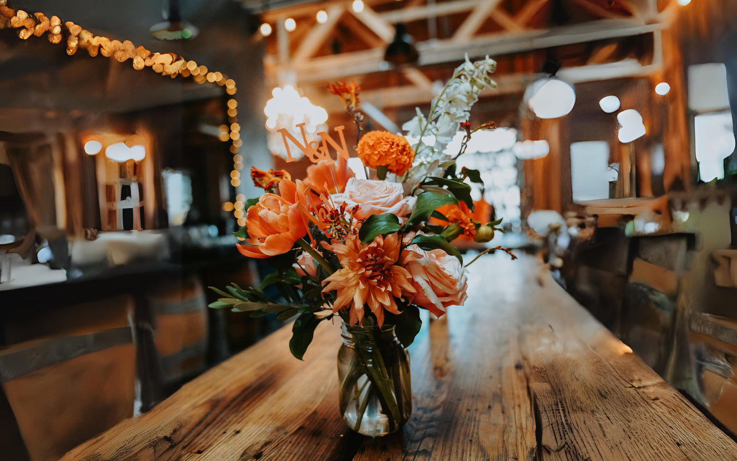 Personalized wedding name sticks displayed in mason jar centerpiece